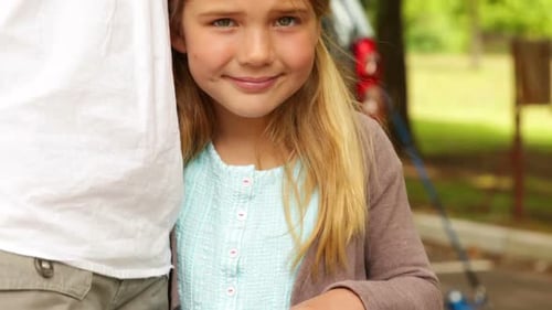 Child and Woman Smiling in Suburban Park
