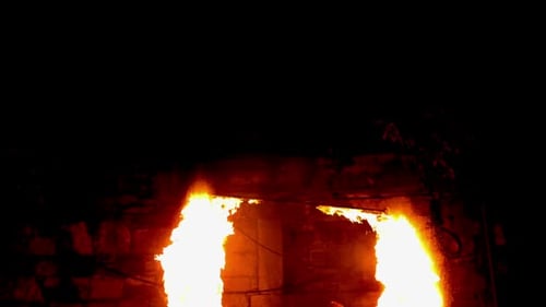 Intense Flames Burning Stone Doorway at Night
