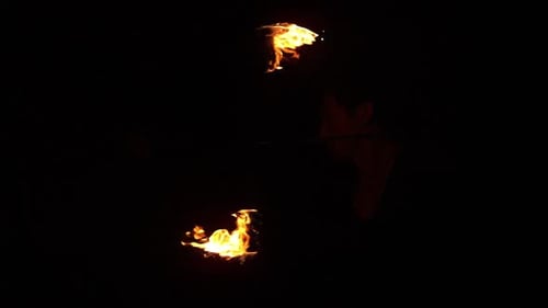 Skilled Fire Dancer Twirling Flames in the Night