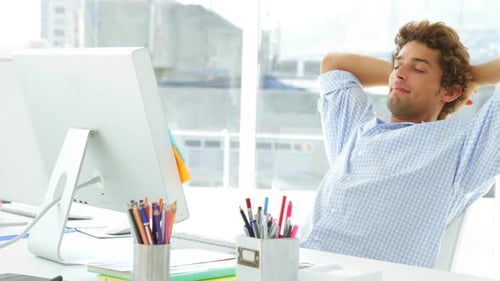 Man Works on Computer in Bright Office