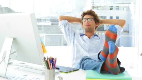 Young Adult Relaxing at Bright Office Desk
