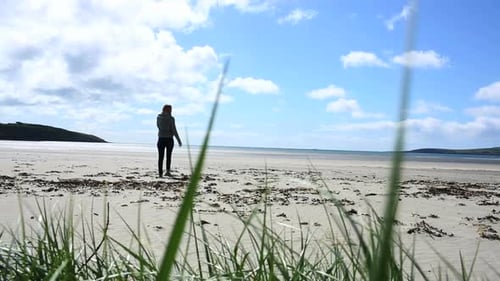 Woman Relaxing And Walking Towards The Sea