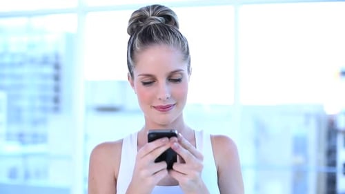 Young Woman Using Mobile Phone Indoors