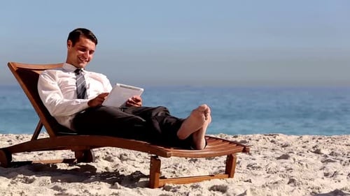 Businessman Lying On The Beach