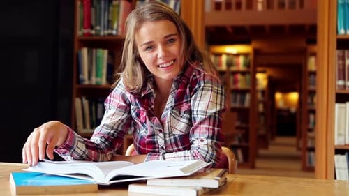 Happy Student Studying At Desk In The Library