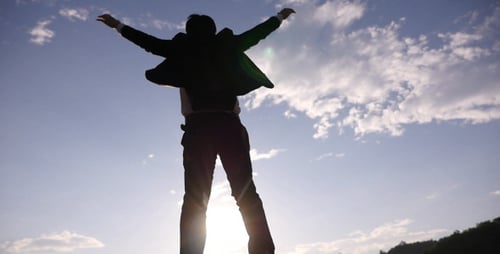 Silhouette Man Climbing Rocks at Glorious Sunrise