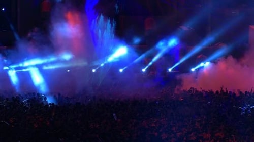 Enthusiastic Crowd Enjoys Colorful Concert at Night