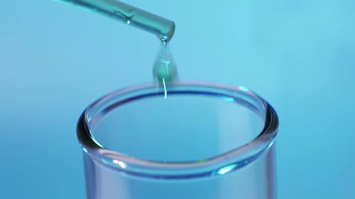 Liquid Drop into Clear Test Tube, Close-Up