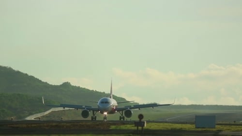 Airplane on Runway in Mountainous Landscape