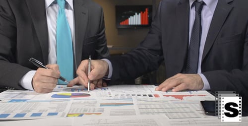 Executives Reviewing Charts and Graphs in Office