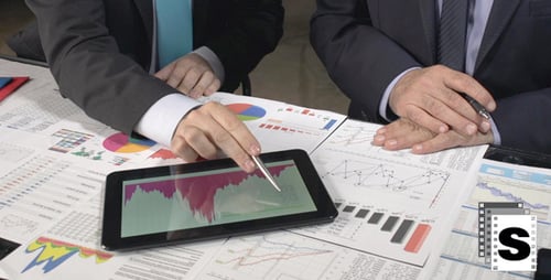 Adults Reviewing Corporate Financial Data in an Office
