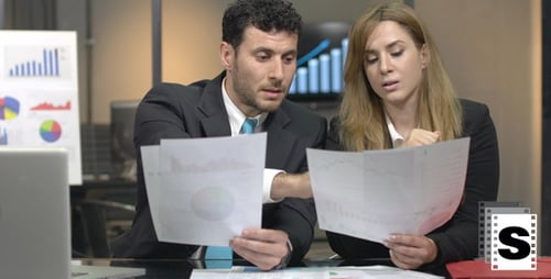 Business Professionals Analyzing Financial Data in Office