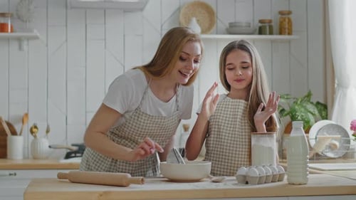 Young Woman and Girl Baking Together at Home