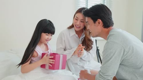 Child Receives Birthday Gift from Loving Family