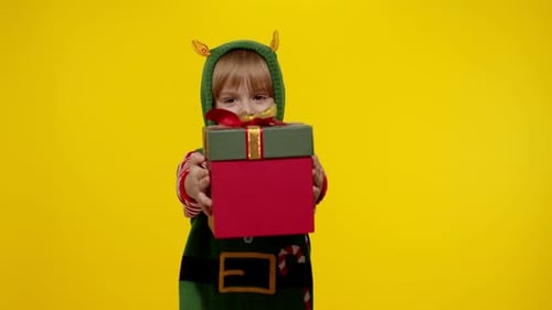 Young Child Dressed as an Elf Presents a Gift