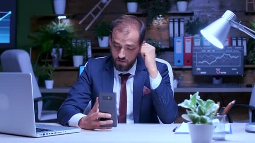Bearded Man Video Conferences in Modern Office Setting