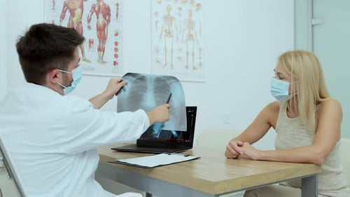 Doctor Explains X-Ray to Patient in Office