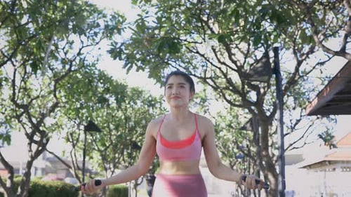 Woman Doing Rope Skipping in the Park
