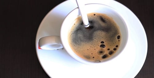 Adding Sugar to Fresh Cup of Coffee