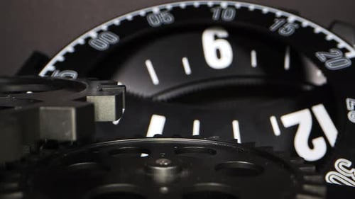 Close Up of Black Gears and Clock Face