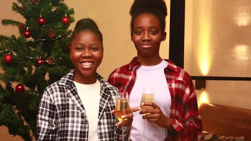 Two Young Women Celebrate Christmas with Champagne