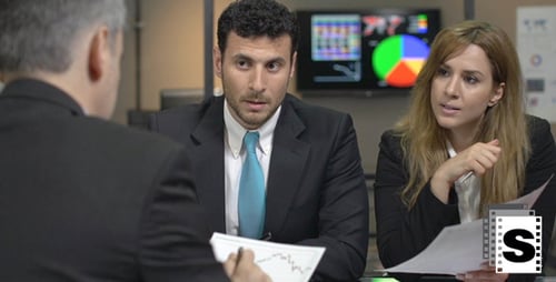 Business Team Reviews Data in Modern Office