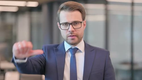 Portrait of Thumbs Down Gesture by Businessman