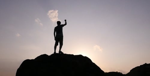 Man Climbing Rock Silhouette at Sunrise