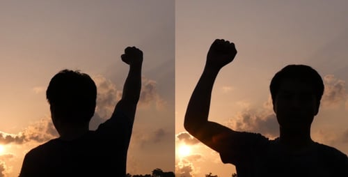 Man Silhouette Arm Raised at Sunrise