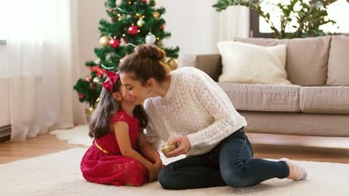 Christmas Joy: Mother and Child Exchanging a Present