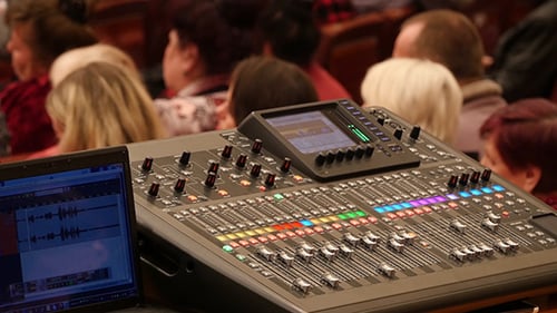 Mixing Console in Front of Blurred Audience