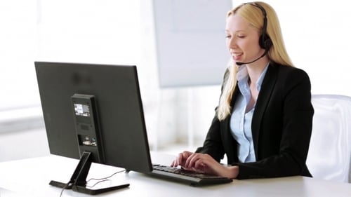 Smiling Helpline Operator Receiving Call In Office