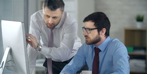 Men Collaborating at Computer in Bright Modern Office
