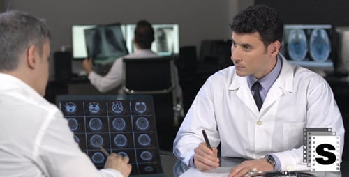 Doctors Discuss Brain Scan Results in Office