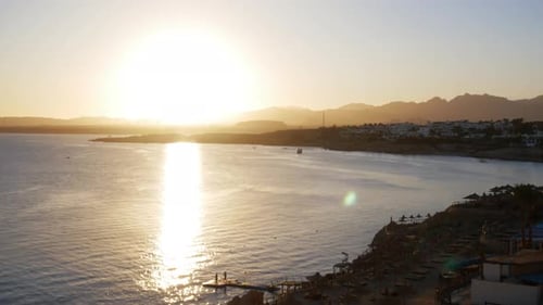 Timelapse of Romantic Sunset on the Sea. Sun Going Down Over Horizon with Mountains at Sunset