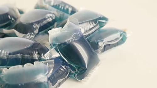 Blue Laundry Detergent Pods on White Surface