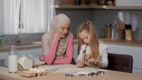Woman and Girl Making Cookies in Kitchen