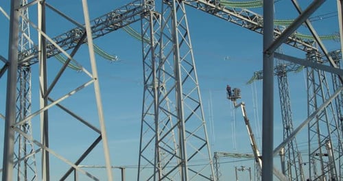 Workers Repairing Power Lines on a Lift
