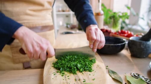 Restaurant Chef Chopping Fresh Parsley on Cutting Board
