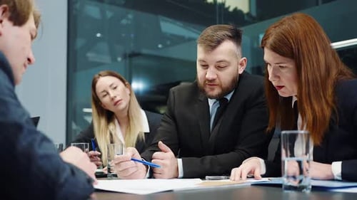 Team Discussing Business in Modern Office Setting