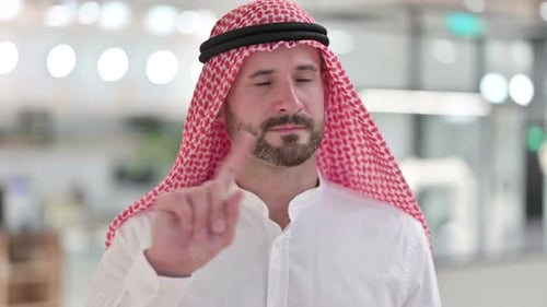 Adult Shakes Finger Wearing Traditional Head Covering