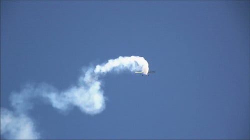Small Plane Performs Aerobatics in Blue Sky