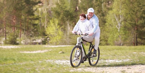 Seniors riding a bike