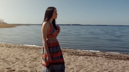 Young Woman Walking On The Sea Beach