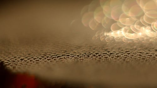 Abstract Droplets with Golden Light Background