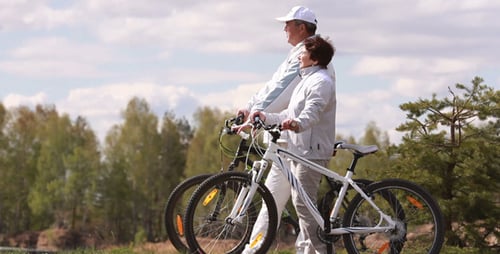 Senior Couple Enjoying Bike Ride Together Outdoors