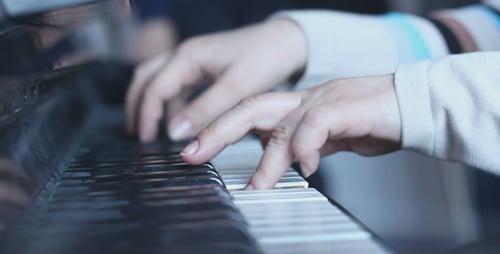 Hands Playing Grand Piano in Close Up