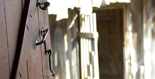 Weathered Wooden Door with Sunlight Streaming In