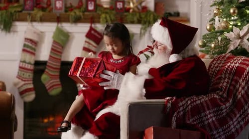 Child Receives Gift from Santa Claus at Christmas