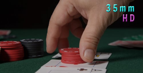 Poker Chips Stacked on Cards on Gaming Table